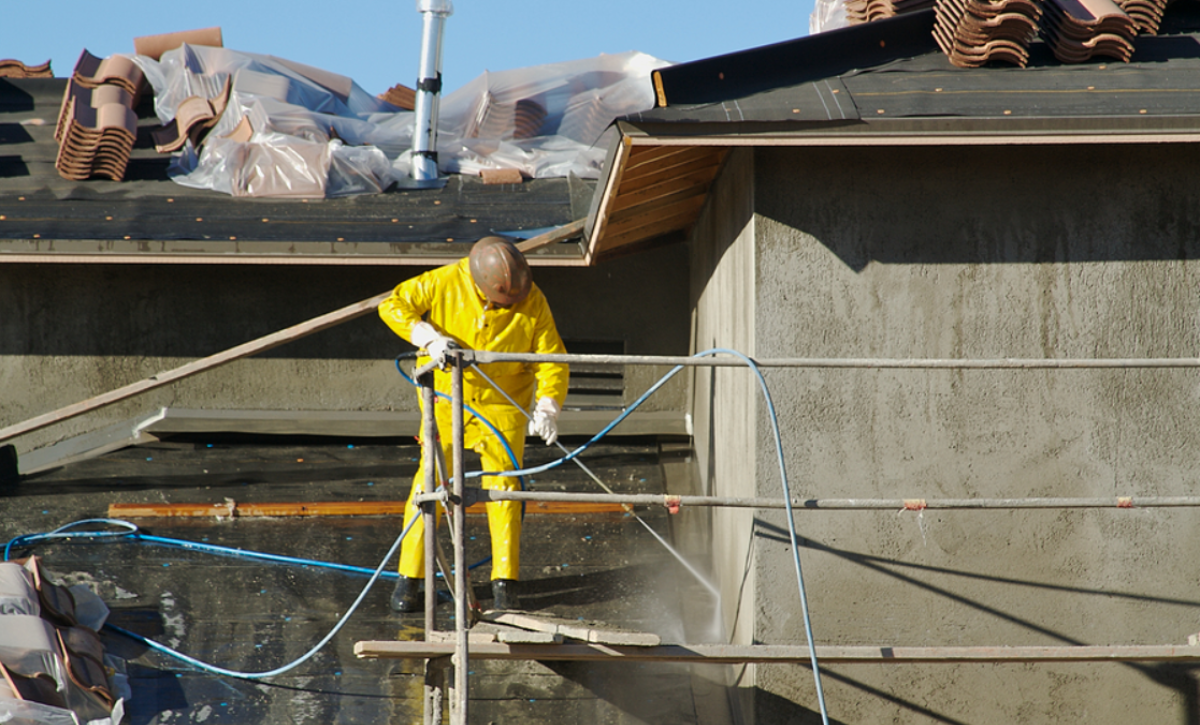 Stucco exterior wall being professionally cleaned and maintained in sunny San Diego home