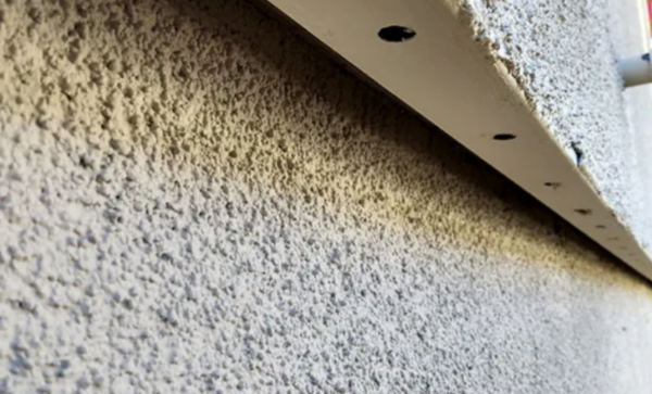Weep screed installed at the base of a stucco wall system
