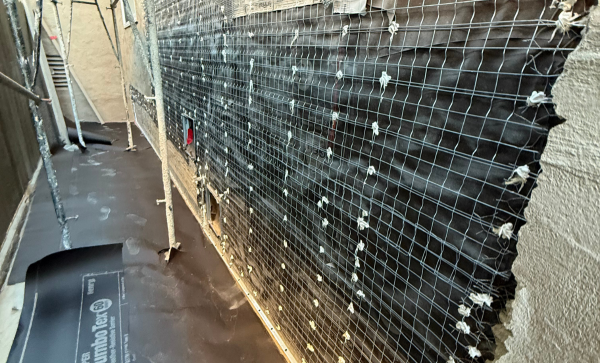 Stucco repair showing exposed metal lath