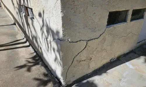 Exterior stucco damage with cracks and water intrusion on a San Diego home
